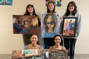  Students holding artwork