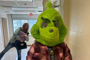  student wearing a Grinch costume