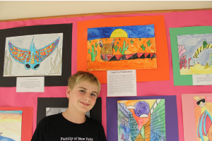  student in front of their artwork